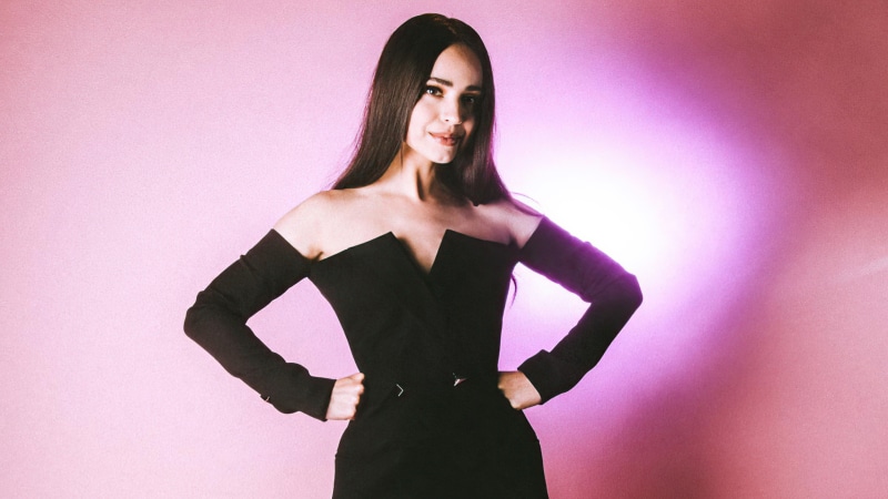 Sofia Carson in a black off-the-shoulder dress
