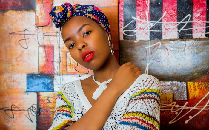 Model with red lipstick and colorful headwrap 4K