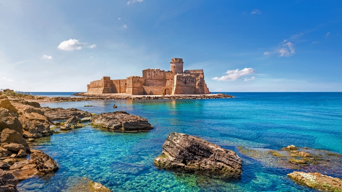 Le Castella castle on the clear blue sea in Italy