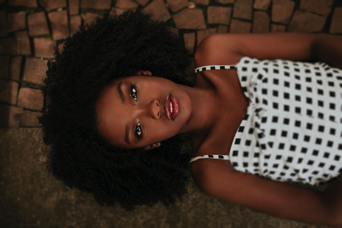 Model Lying Down with Black Curly Hair