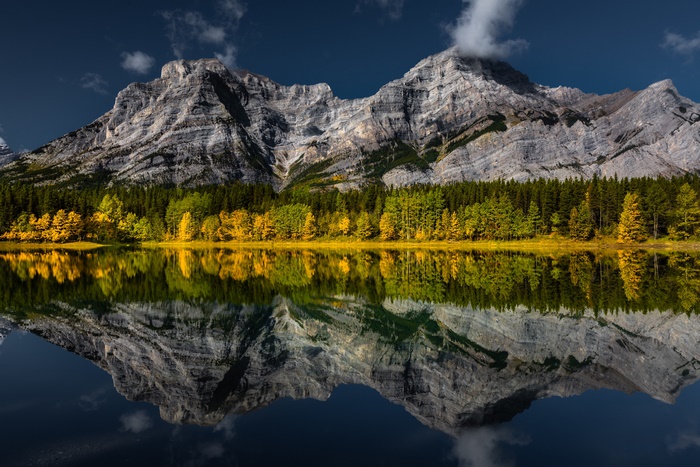 Majestic Mountains and Autumn Forest Reflected in Lake
