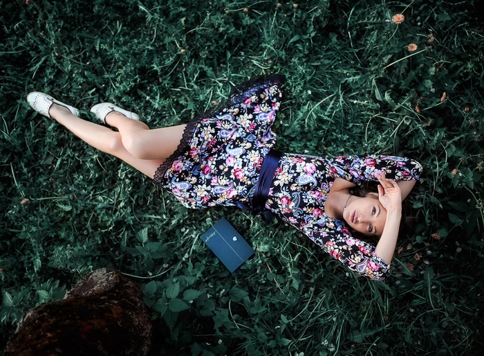 Model Lying Down in Floral Dress on Grass