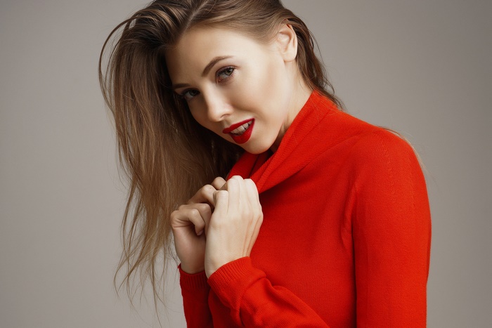 Brunette model in red sweater with red lipstick