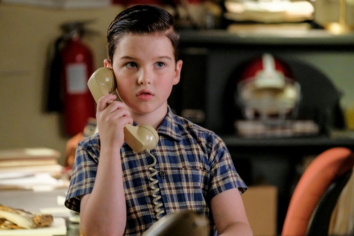 Young Sheldon Cooper talking on a vintage phone