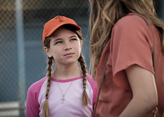 Young Sheldon's Missy Cooper in orange cap and braids