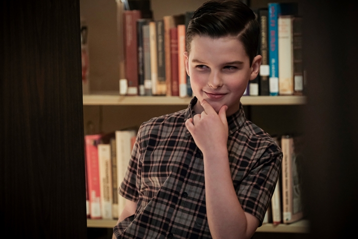 Sheldon Cooper smirking in a library
