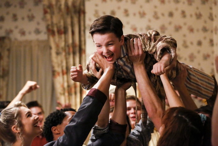 Sheldon Cooper lifted in celebration by many hands