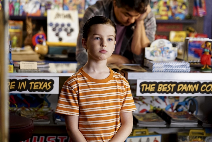 Young Sheldon looking thoughtful in comic shop