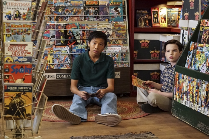 Young Sheldon and friend in a comic book store