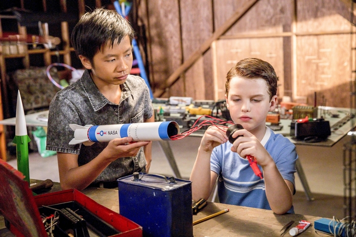 Young Sheldon and friend building a model rocket