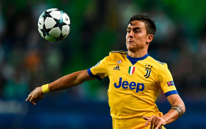 Paulo Dybala eyes soccer ball in Juventus F.C. jersey