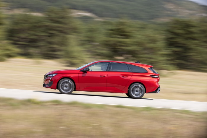 Red Peugeot 308 SW GT in motion