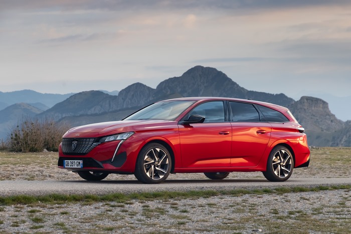 Red Peugeot 308 SW GT in mountainous landscape