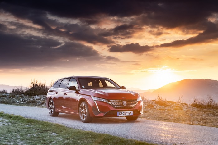 Red Peugeot 308 SW GT at scenic sunset