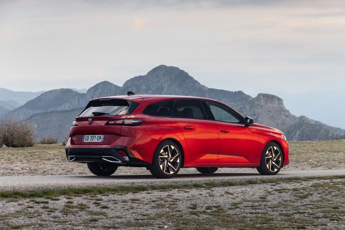 Red Peugeot 308 SW GT in mountain landscape