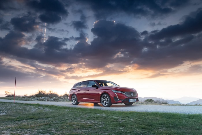 Red Peugeot 308 SW GT at sunset