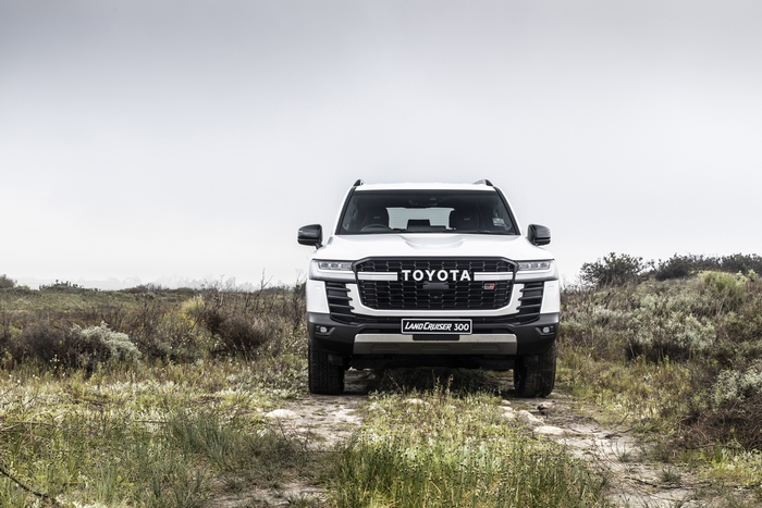 White Toyota Land Cruiser GR-S SUV on a dirt path