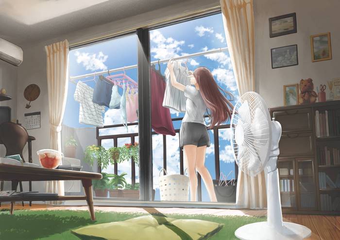 Long-haired girl hanging laundry on a sunny day