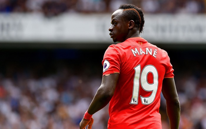 Sadio Mané in Liverpool F.C. jersey looking over shoulder