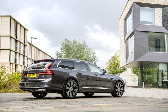 Volvo V90 luxury wagon parked by contemporary architecture