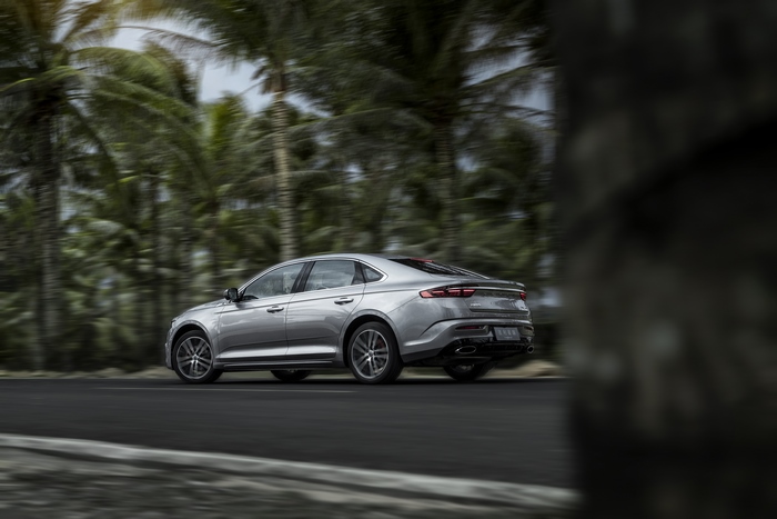 Silver Geely Preface Sedan Driving Past Palm Trees