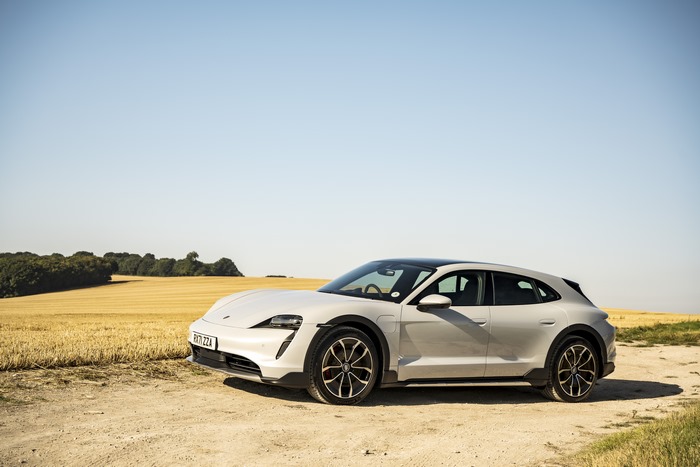 White Porsche Taycan 4S in a golden field