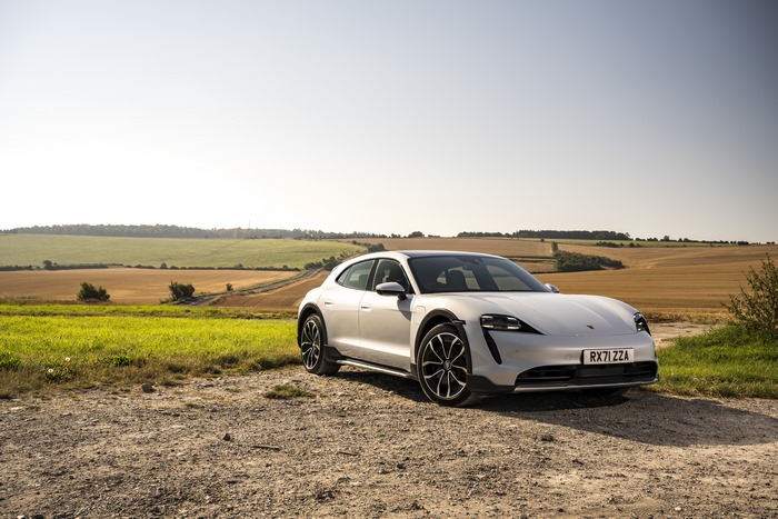 White Porsche Taycan 4S in scenic rural landscape 4K