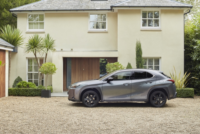 Lexus UX 250H luxury SUV parked outside a home
