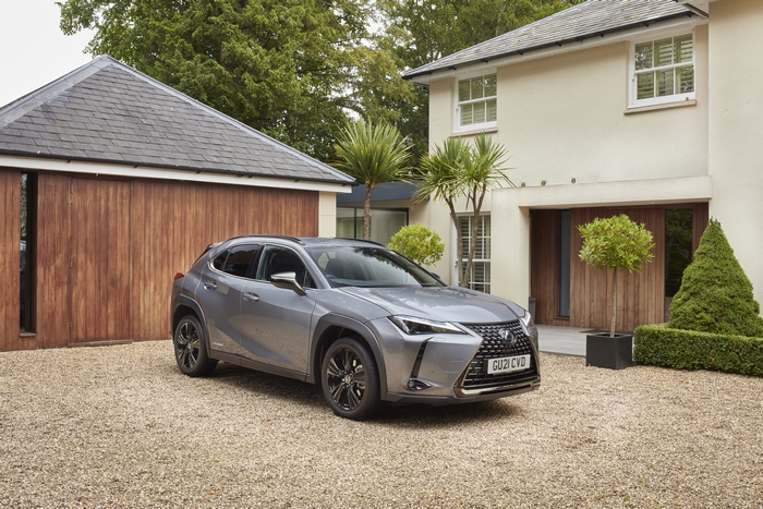 Lexus UX 250H luxury SUV parked at a modern house