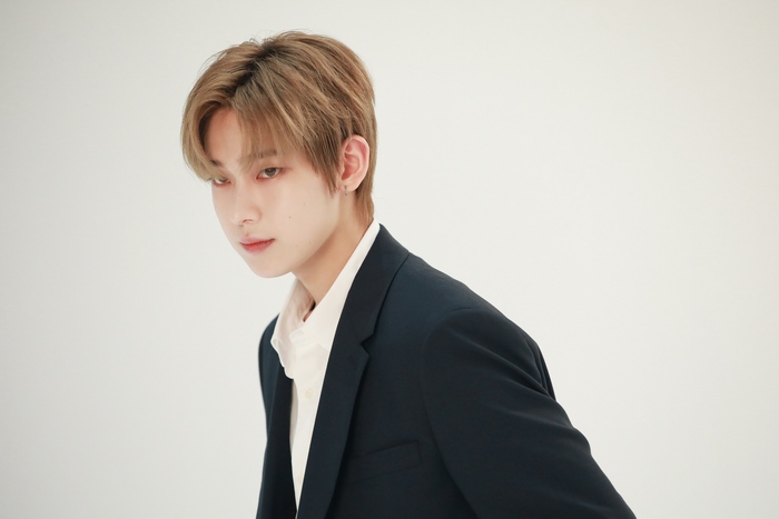 Sunoo in a dark suit jacket
