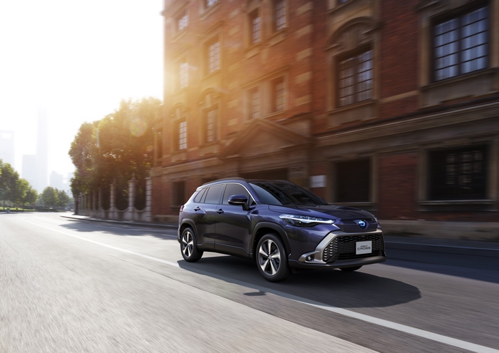 Toyota Corolla Cross Hybrid SUV driving in city