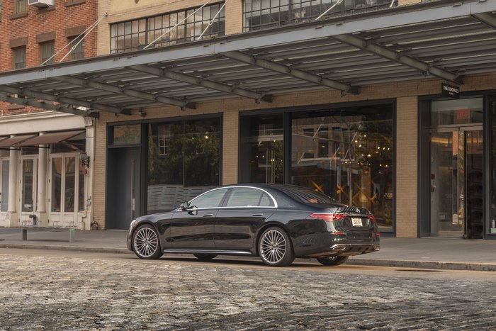 Black Mercedes-Benz S-Class parked on a cobblestone street