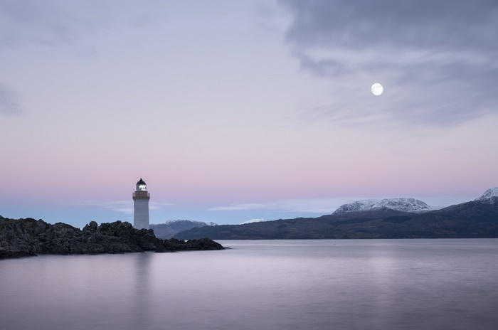 Lighthouse, Moon, and Pink Sky over Mountains
