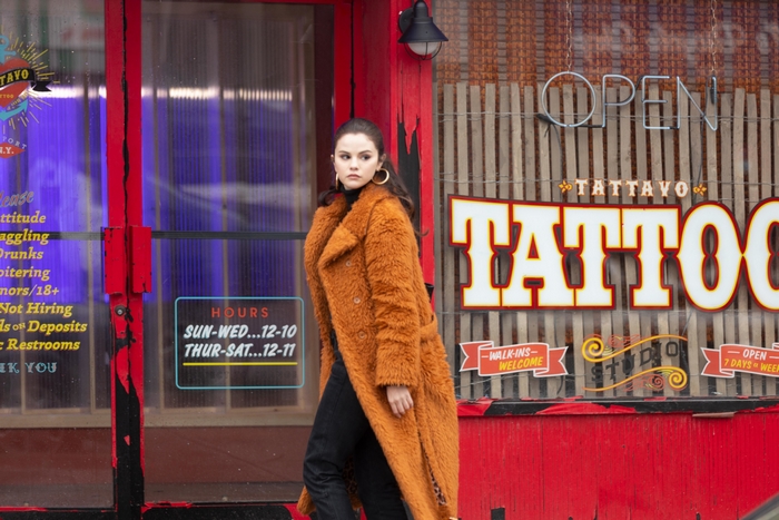 Selena Gomez from Only Murders In The Building in orange coat