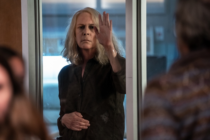 Jamie Lee Curtis presses hand on glass in Halloween Kills