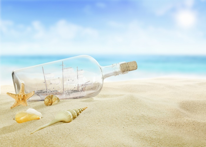 Ship in a Bottle and Seashells on a Sandy Beach