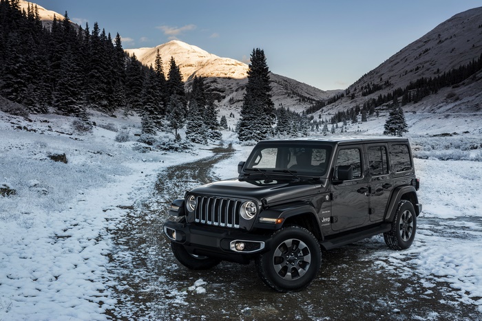 Black Jeep Wrangler Sahara in snowy mountains