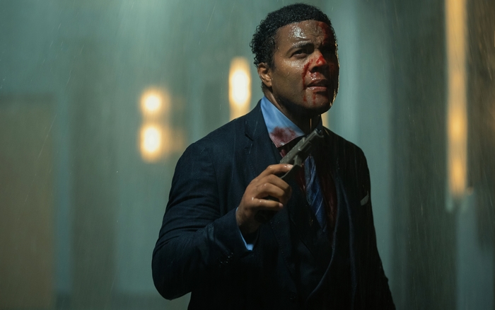The Protégé: Ray Fearon, bloody, holding a gun