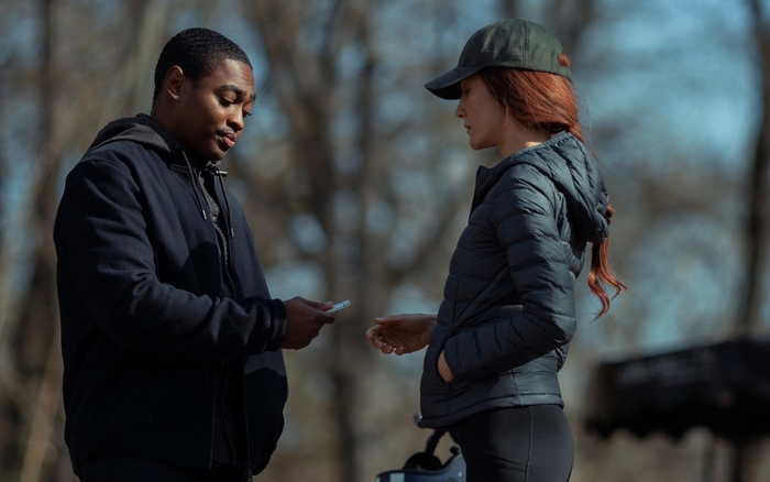 Maggie Q and man exchange item in The Protégé