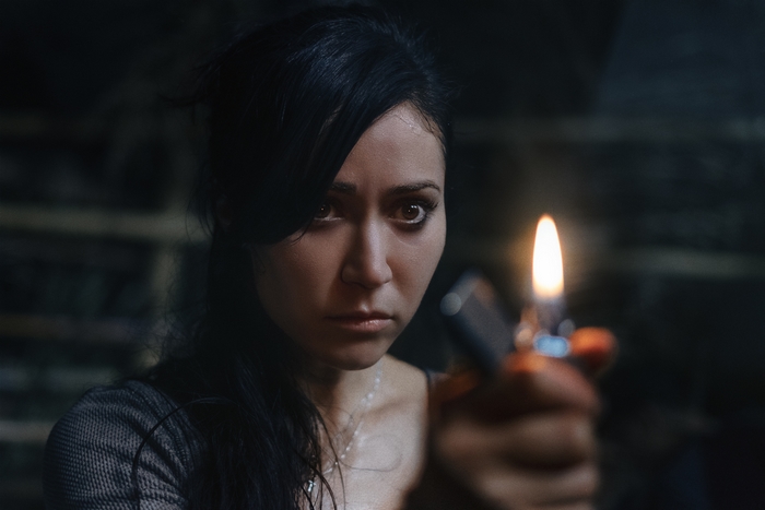 The Old Ways: Brigitte Kali Canales with a lit lighter
