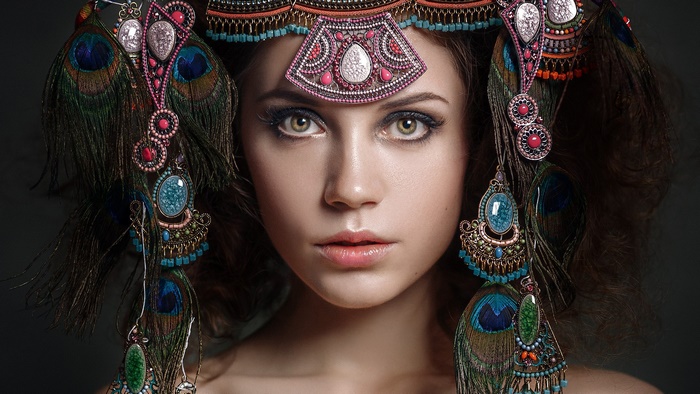 Kseniya Kokoreva wearing an elaborate peacock feather headdress