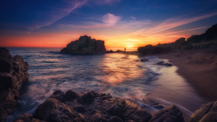 Vibrant Sunset over Rocky Coastline