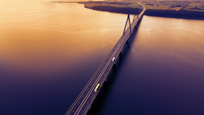 Aerial view of cable-stayed bridge over water at sunset