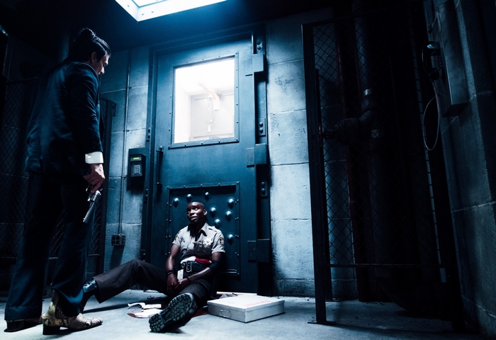 Frank Grillo holds a gun on a wounded cop