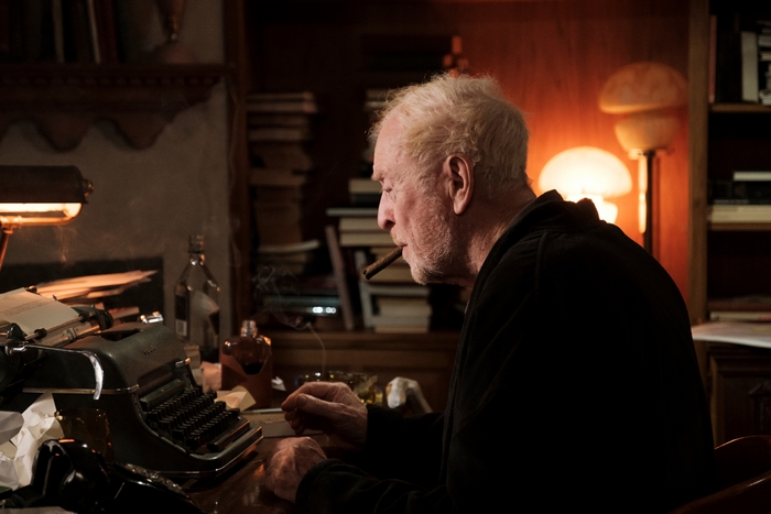 Michael Caine writing with a cigar and typewriter in Best Sellers