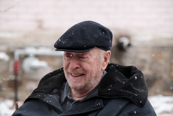 Michael Caine smiling in falling snow