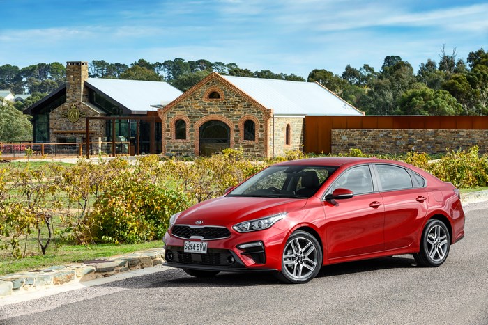 Red Kia Cerato parked at a winery