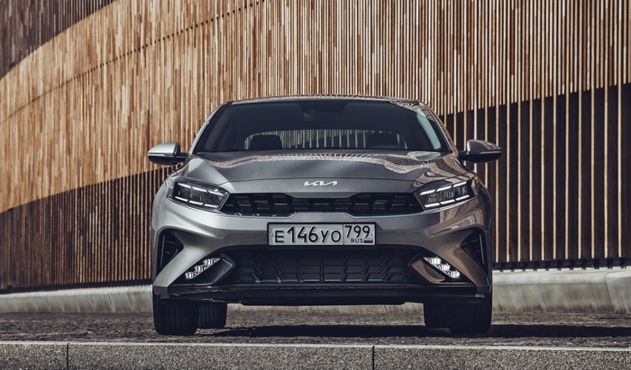 Kia Cerato parked in front of a wooden wall