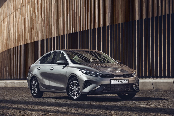 Kia Cerato 4K compact car parked by wooden wall