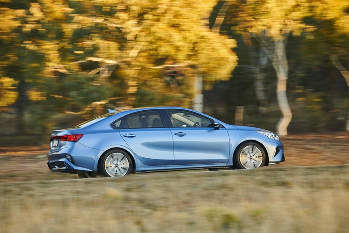 Blue Kia Cerato Sport Plus compact car in motion
